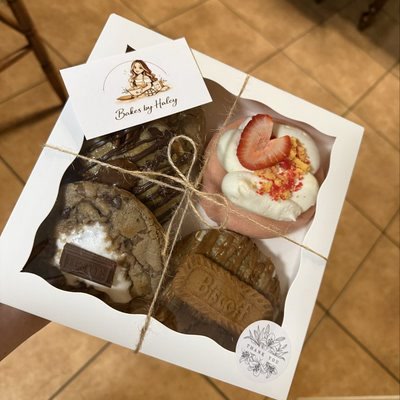 Gift box with cookies and a strawberry cupcake tied with twine